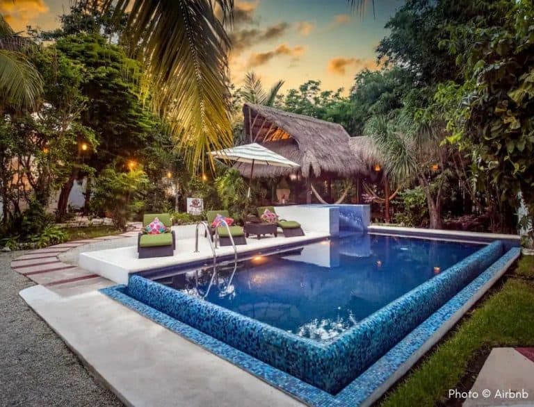 wood cabin pool in a garden at sunset