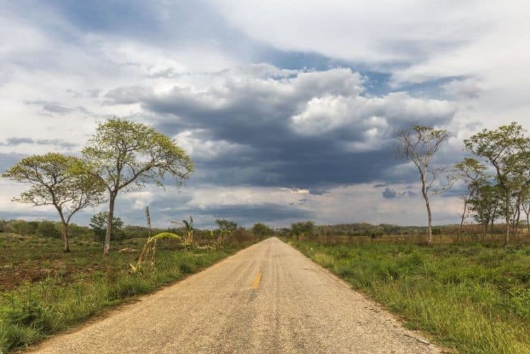 road in the countryside with a cloudy sky