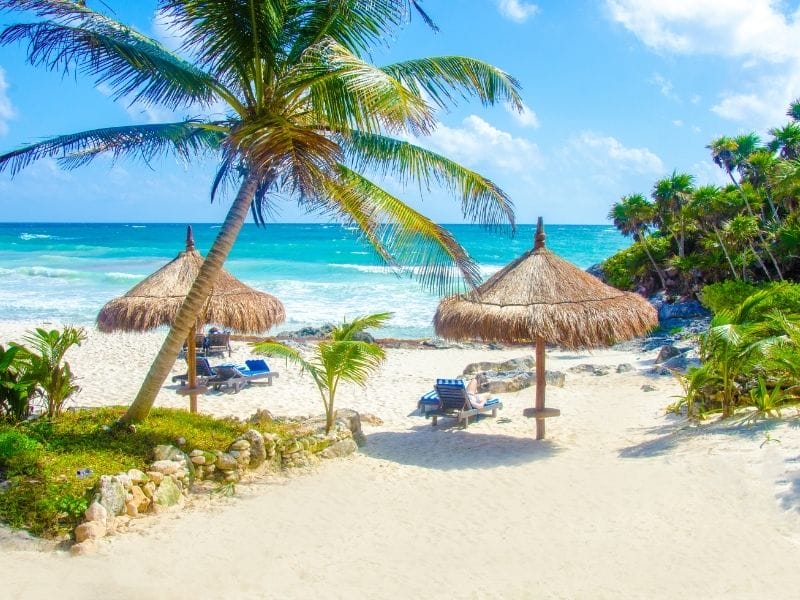 beach chairs on a beach in Tulum