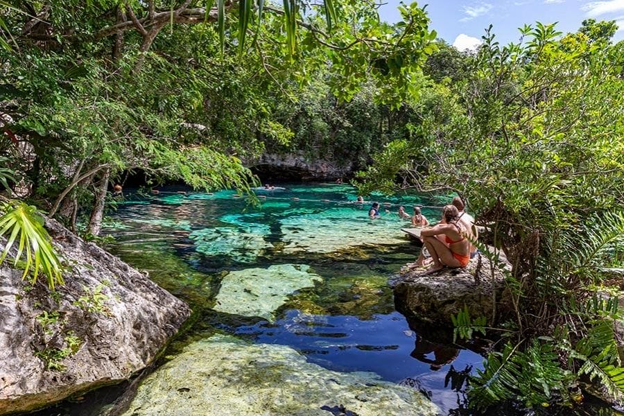 cenote azul, couple sitting by the pool