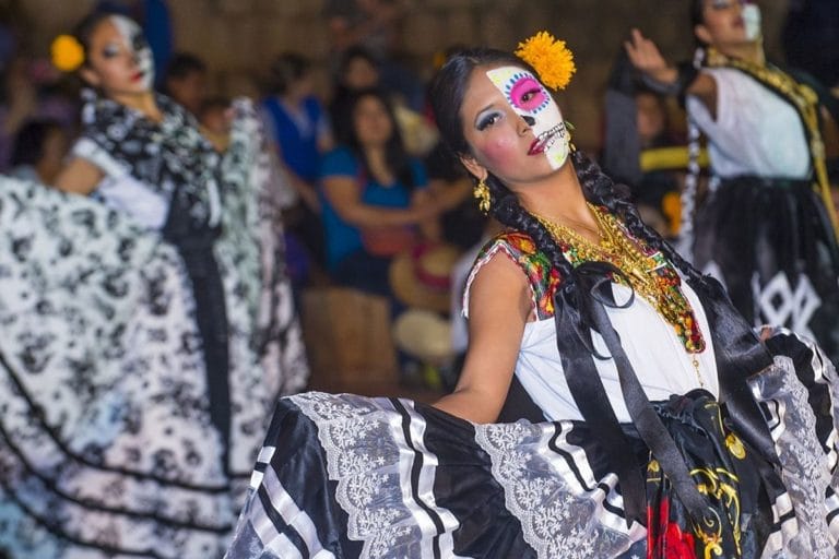 Day of the dead girl with painted face dancing