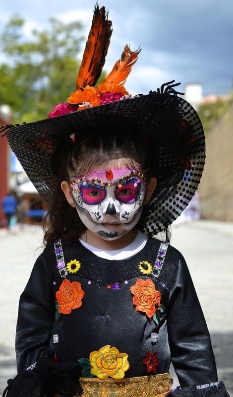kid with painted face on dia de muerto mexico