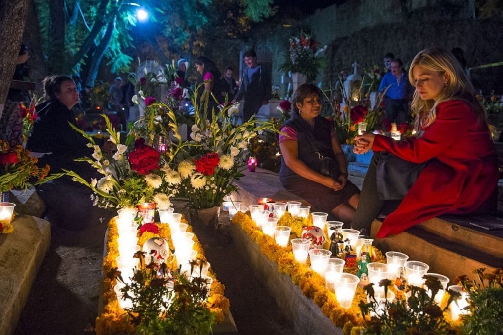 People by a grave in Oaxaca