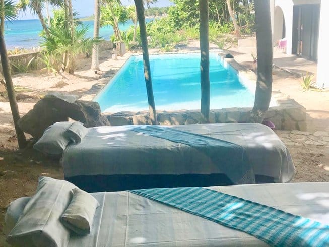 beach beds by a pool on a beach