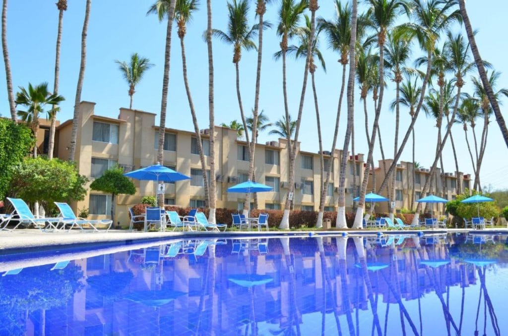 Palmira Hotel Overview pool surrounded by palm tree