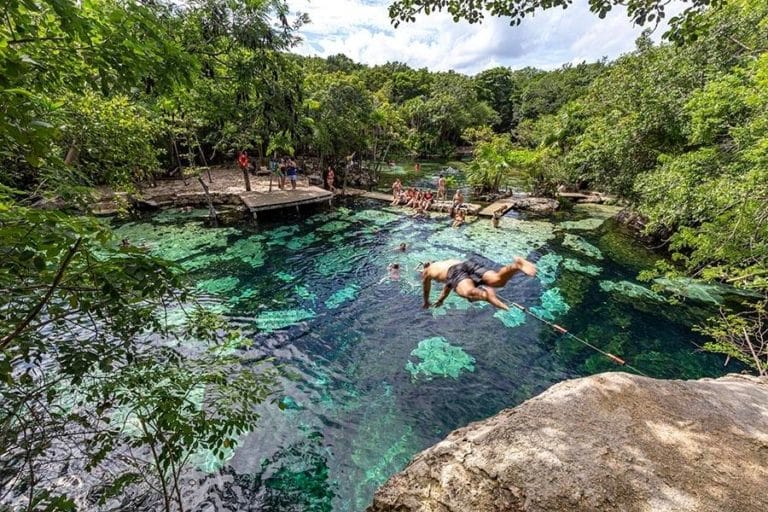Cenote Azul guy jumping head first