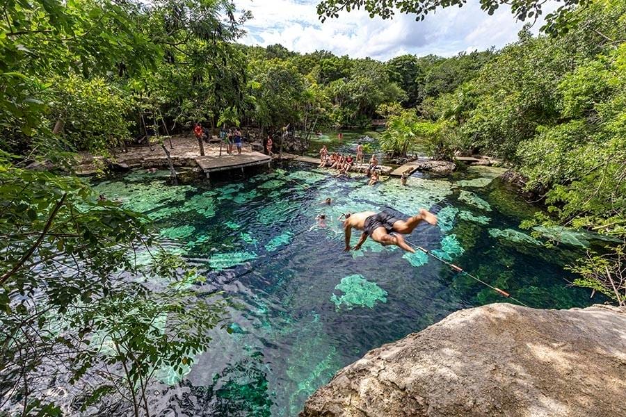 Cenote Azul guy jumping head first