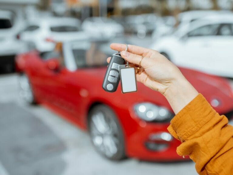 a woman holding the car keys