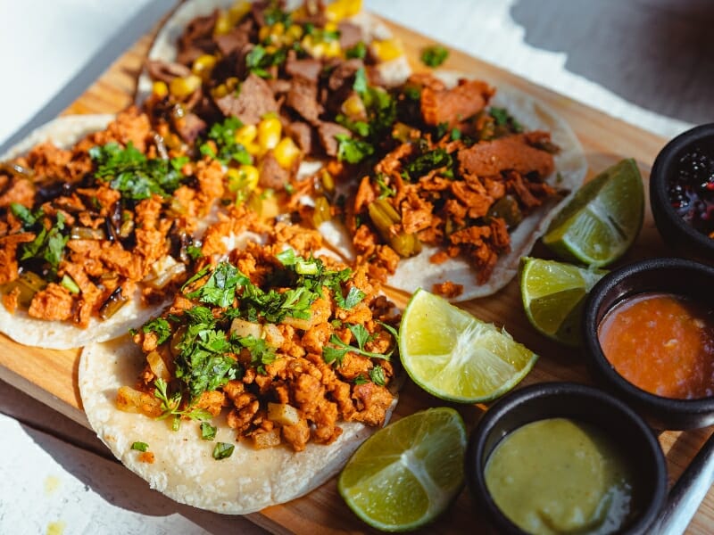 Close up of tacos on a wooden chopping board