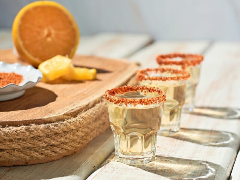 Mexican mezcal shot with chili pepper and orange