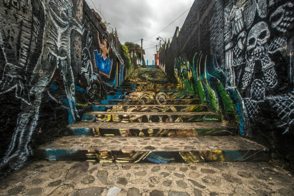 View of a stair in Orizaba Veracruz with murals on the wall.
