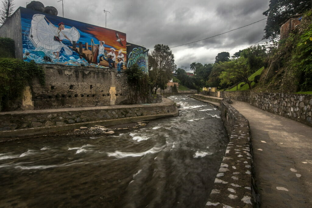 View of a strong current river under a cloudy day.