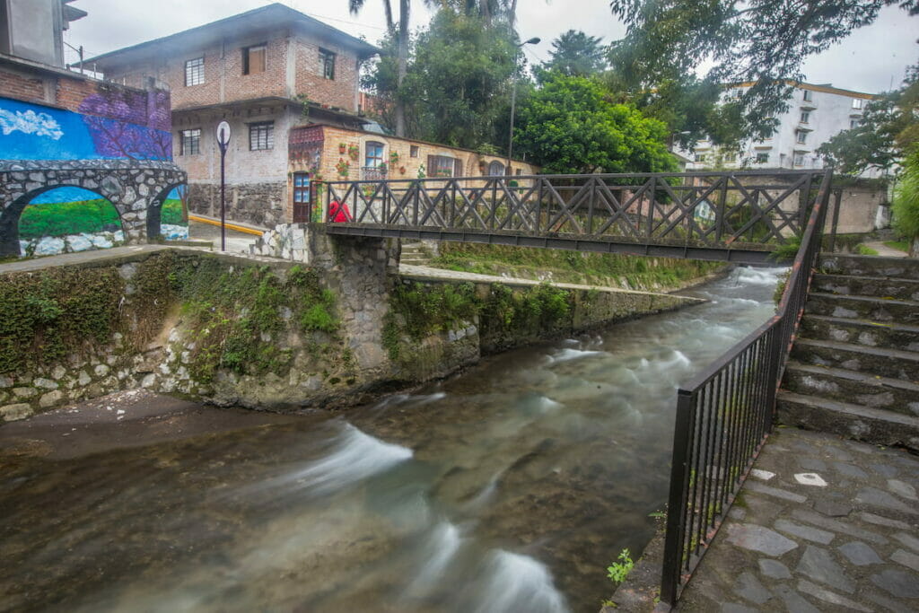 View of a small bridge and a strong current river under a cloudy day in Orizaba Veracruz.