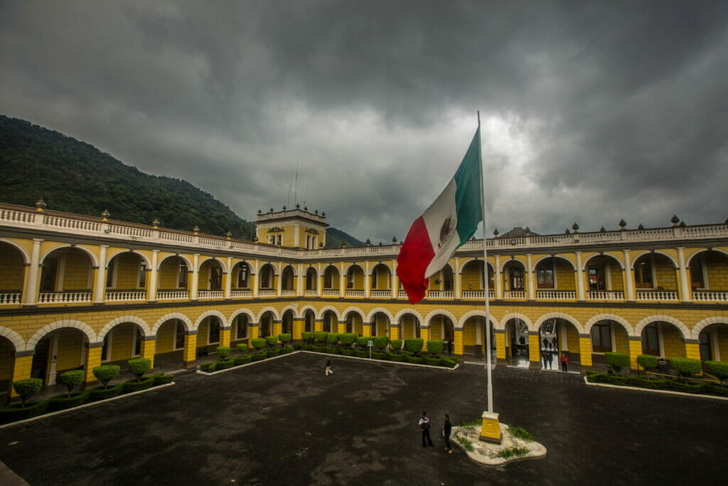 View of Orizaba Veracruz Magico with the Mexican flag in the middle under a cloudy day.