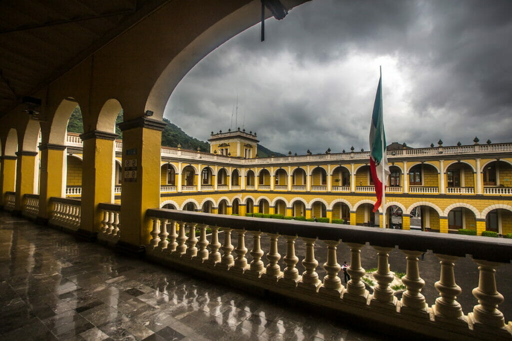 View from the hallway of Orizaba Veracruz Magico with the Mexican flag in the middle under a cloudy day.