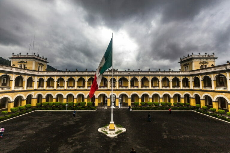 View of Orizaba Veracruz Magico with the Mexican flag in the middle under a cloudy day.