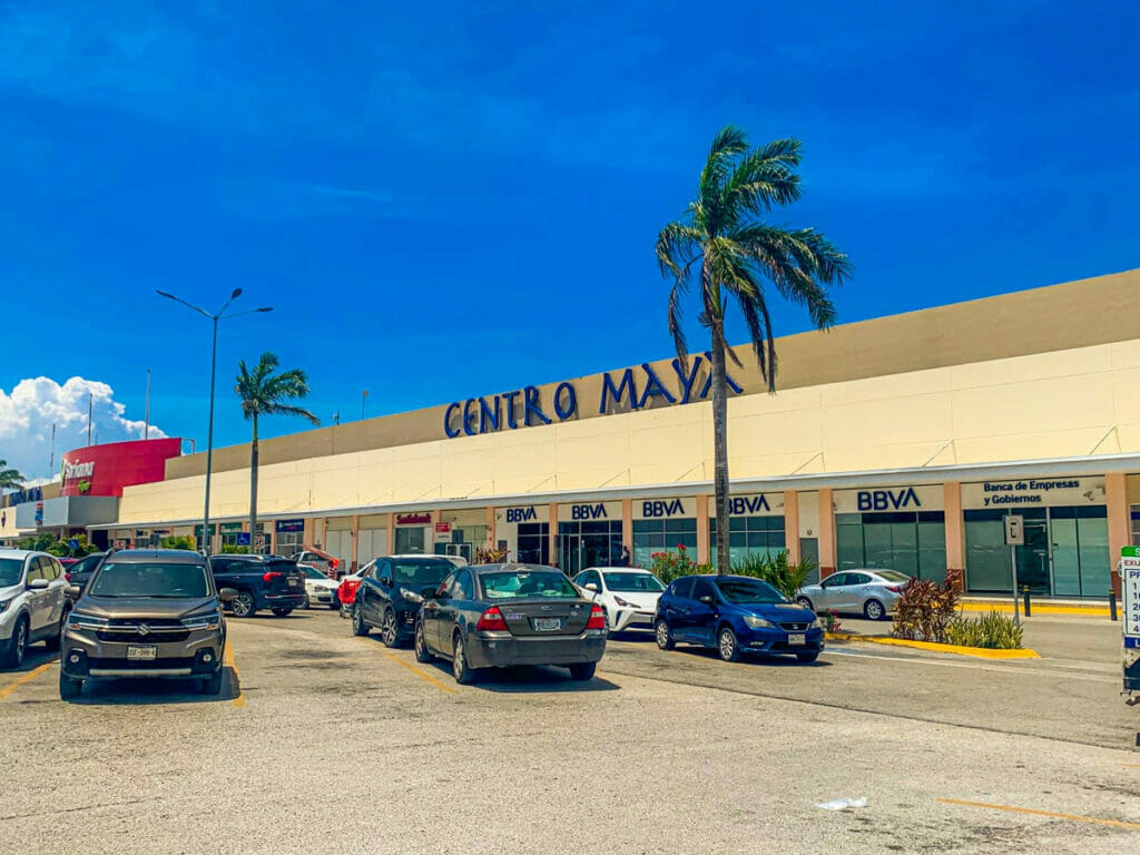 View of the Centro Maya Shopping Mall and cars parked.