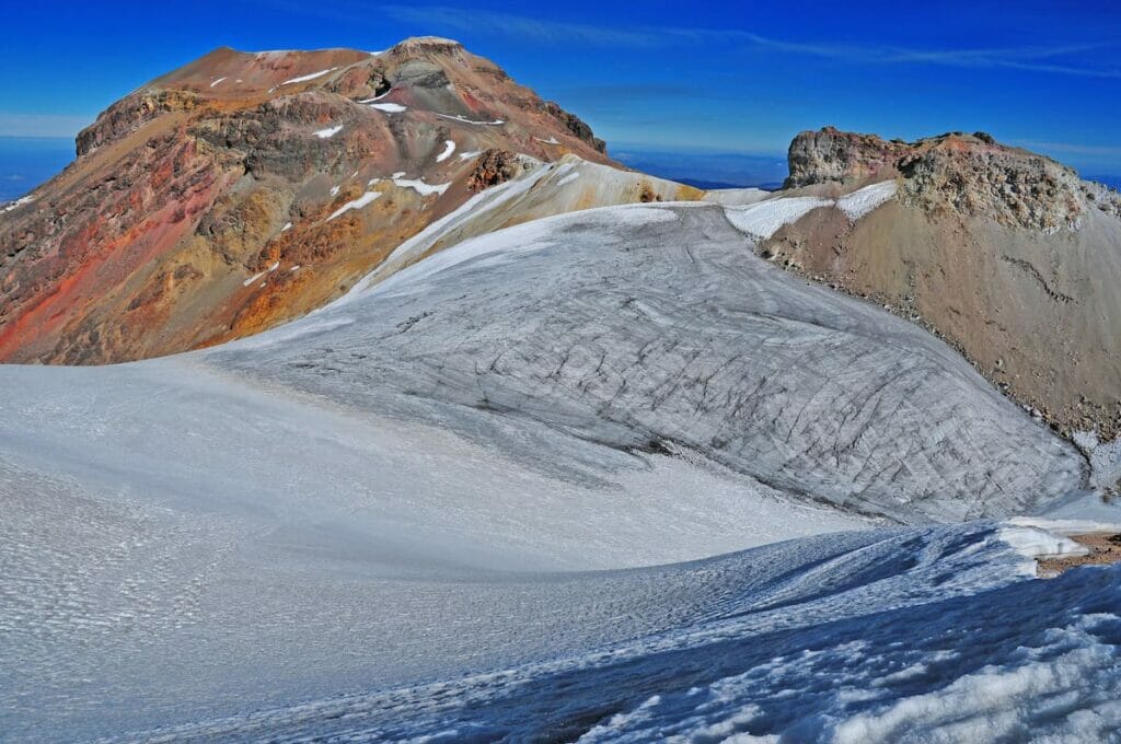 View of Iztaccihuatl under a blue sky.