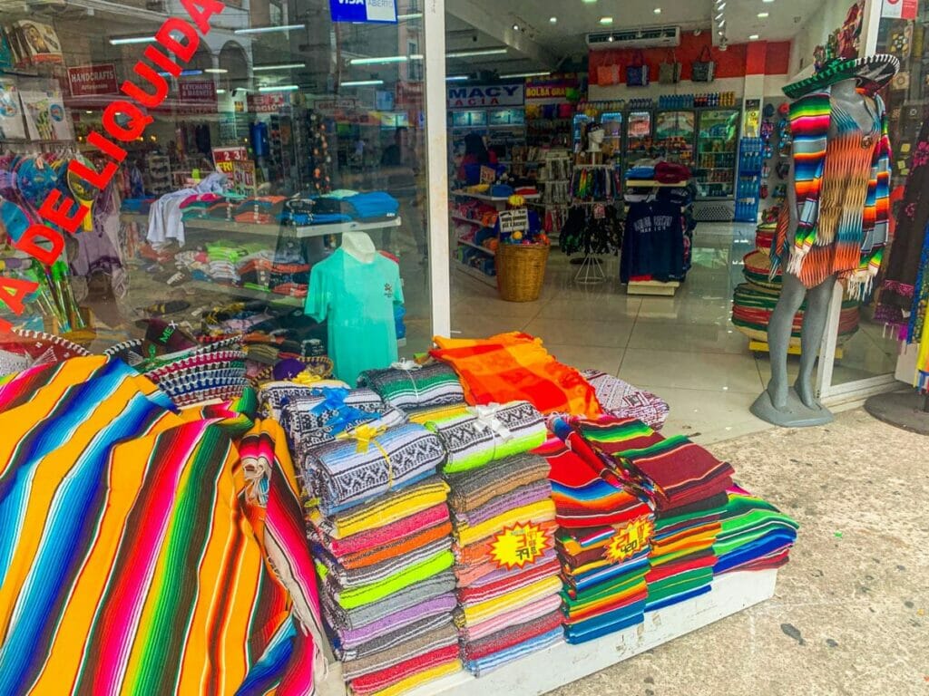 View of a small souvenir stall with their products on the floor.