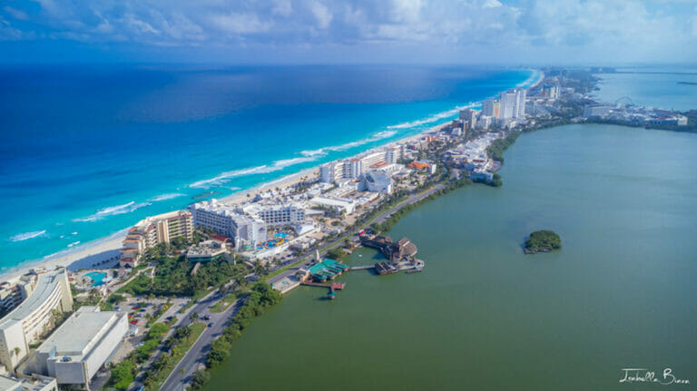 Aerial shot of the Cancun Hotel Zone with Nichupte Lagoon on one side and the ocean on the other side.