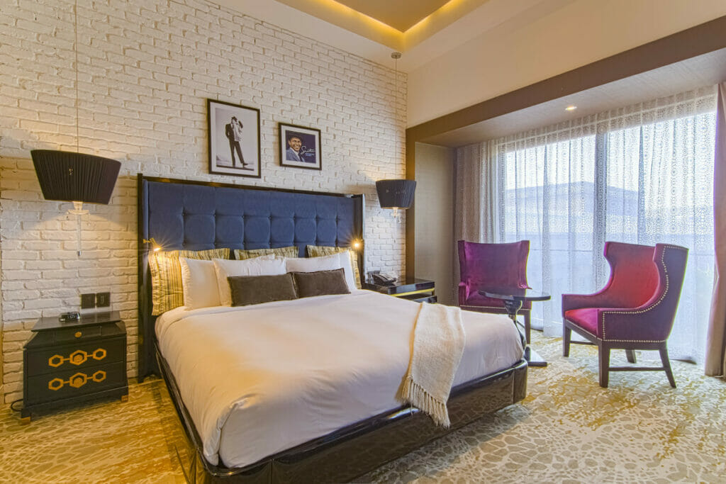 K Tower Boutique Hotel with cozy bed.