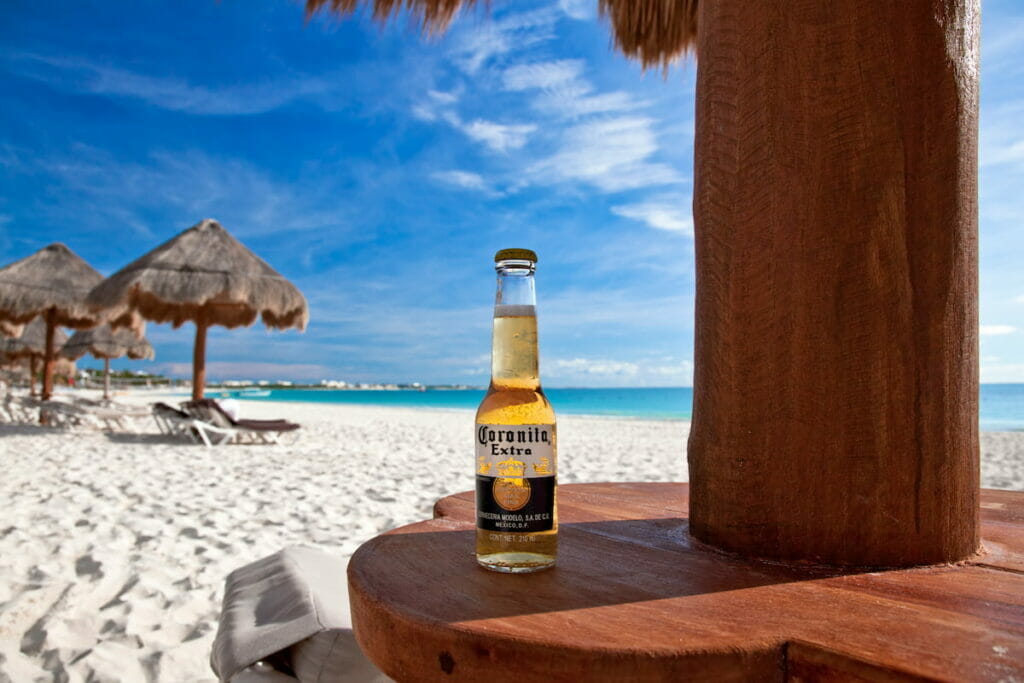 A bottle of beer on a table in one of the huts in Maroma Beach.