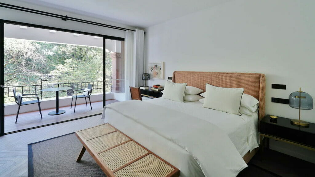 View of a kingsize bed near the balcony.
