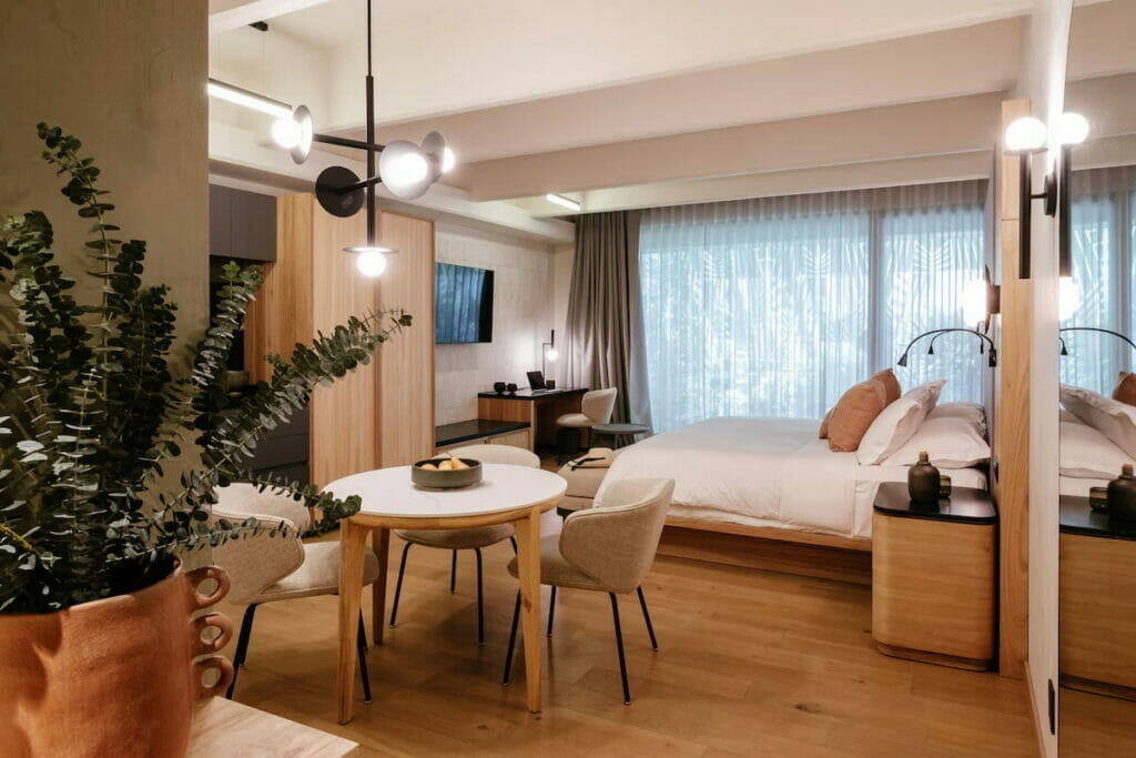 A hotel in Mexico City with a bed and small dining table set.