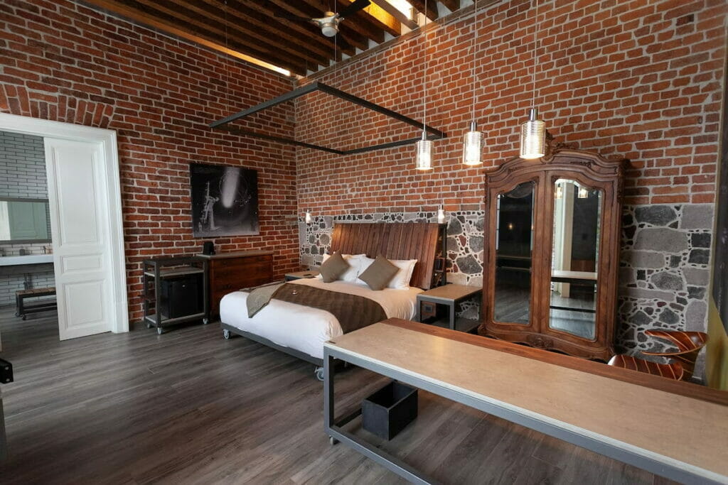 A spacious hotel in Mexico City with brick-design walls.