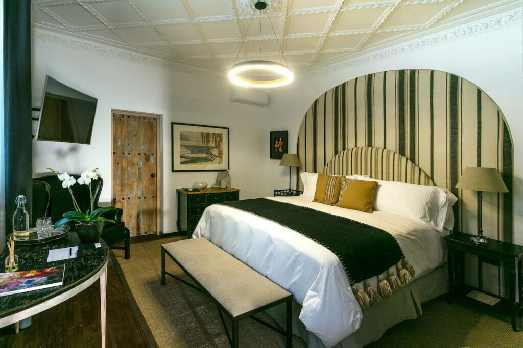 View of a bed with striped headboard.