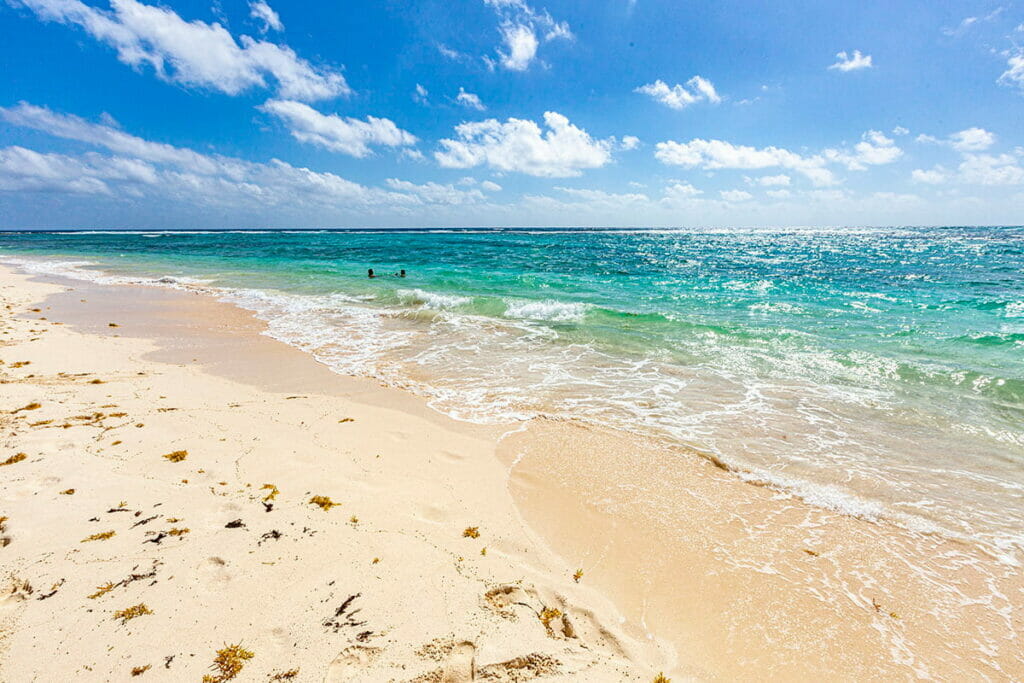 View of Playa Xcacel where people are swimming.