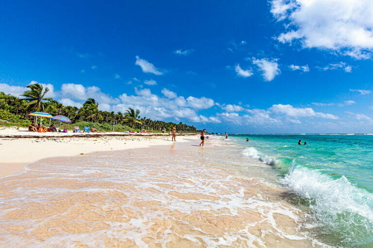 View of Xcacel Beach with tourists.