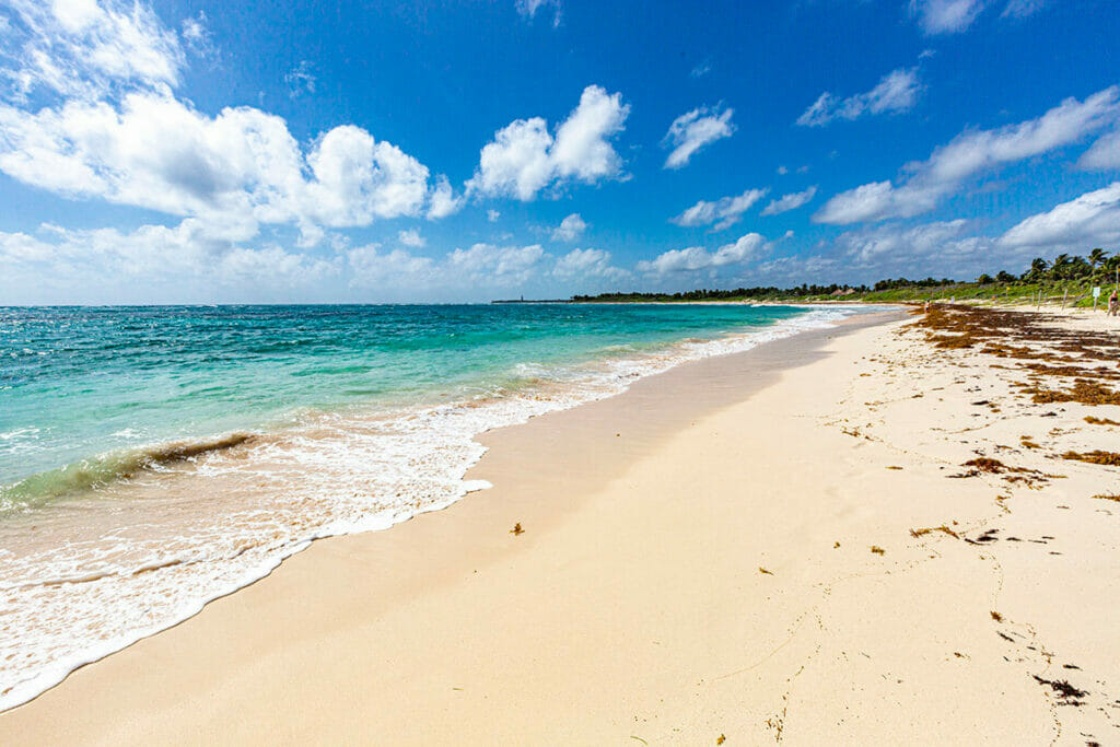 View of clean shore of white sand in Xcacel Beach.