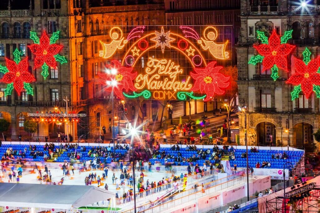 An ice skating rink in Mexico City filled with people and Christmas decor.