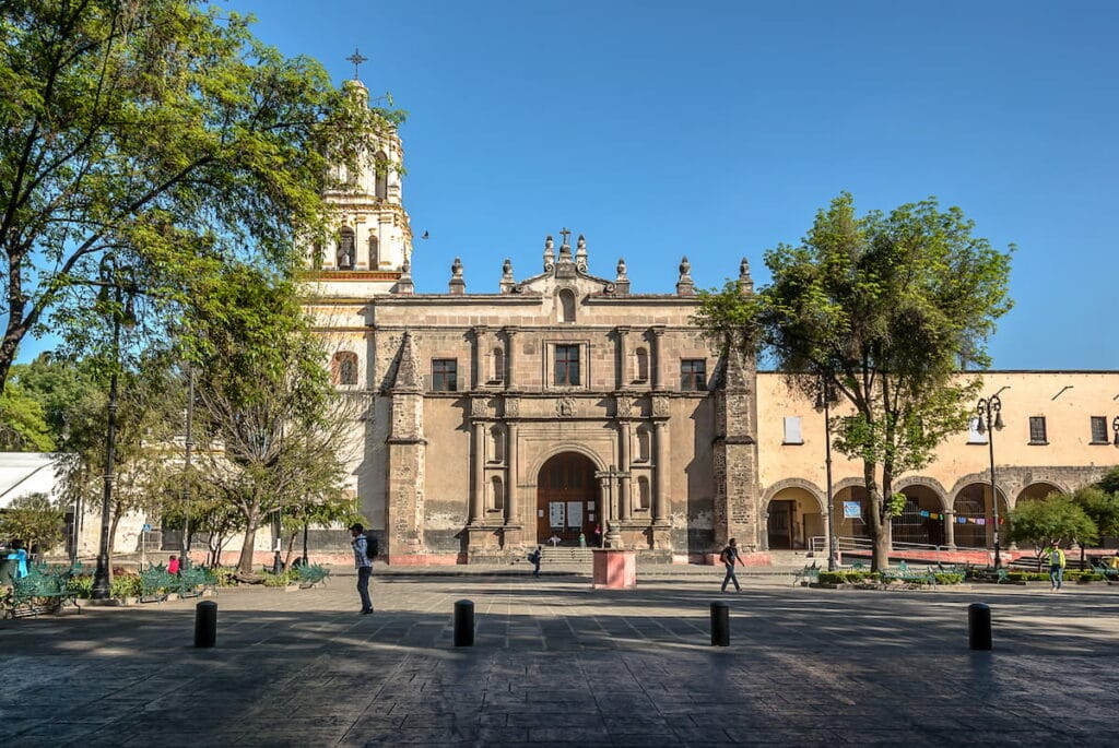 San Juan Bautista Parish Church in Coyoacan under a clear blue sky.