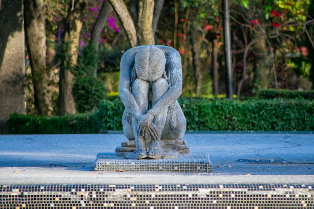 The Statue of Sad Sit Woman Fountain in Frida Kahlo Park in Coyoacan.