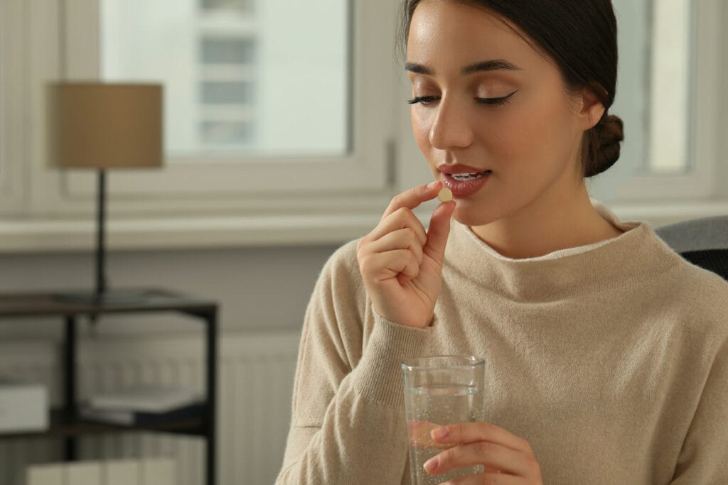 A woman drinking her medicine - Mexico City altitude sickness guide.
