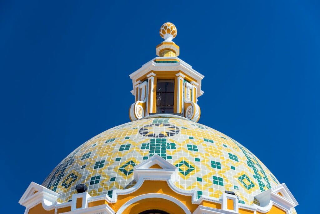 The Church of Our Lady of Remedies dome under a clear blue sky.