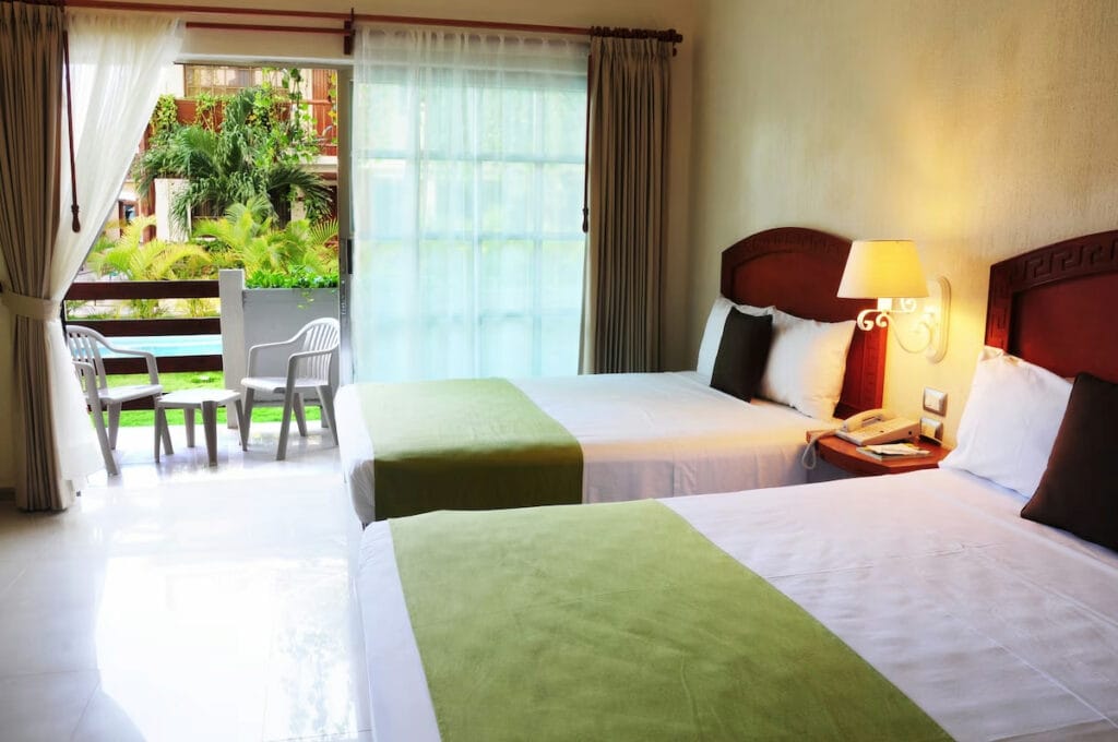 A couple of beds in a room in Hotel Posada.