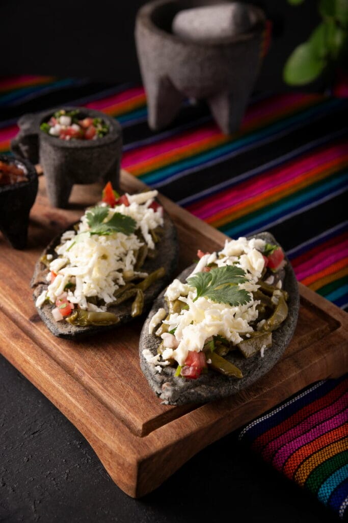 Tlacoyos on a wooden board.