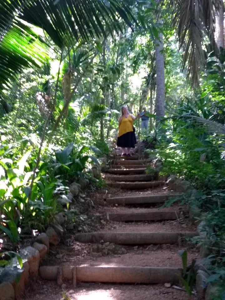 A woman standing on steps in Lo de Perla Jungle Garden