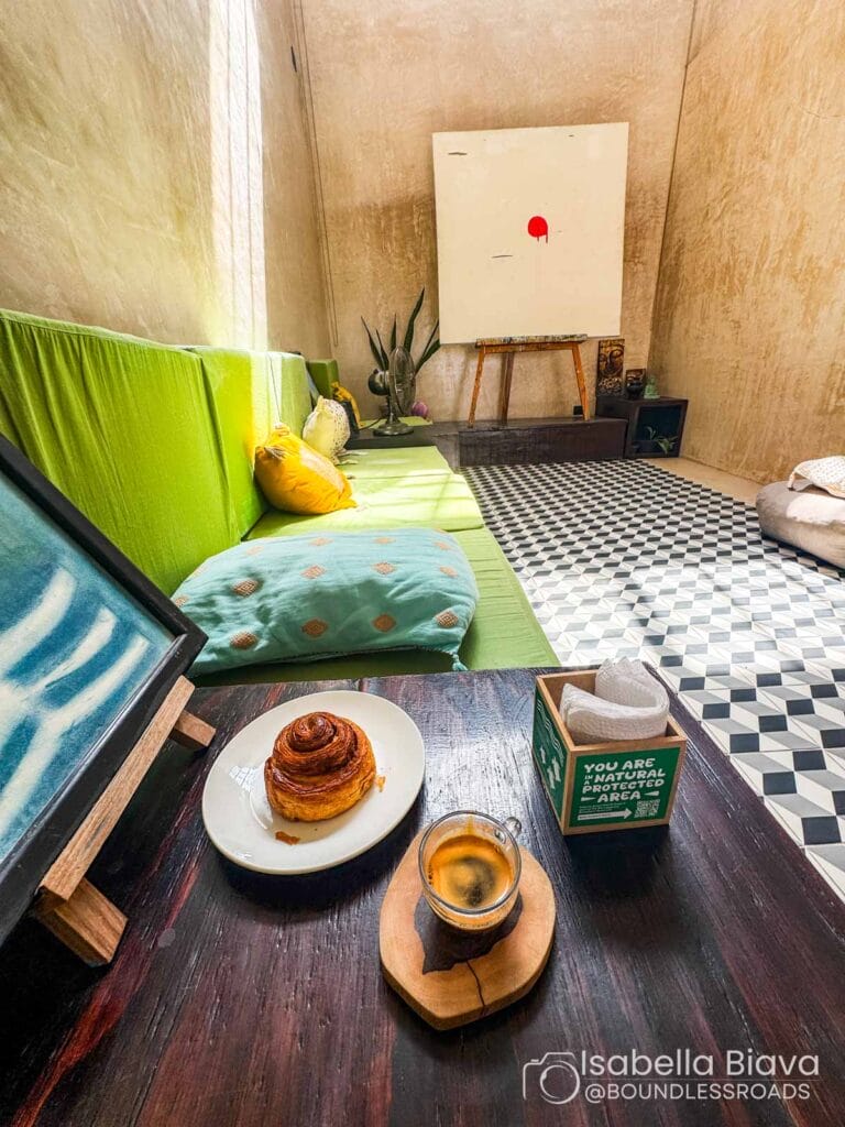 Cozy room with coffee, pastry, and abstract art.