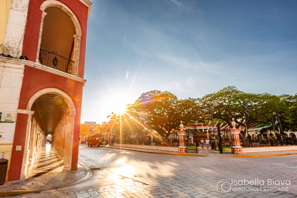 Sunlit colonial street with arches and trees