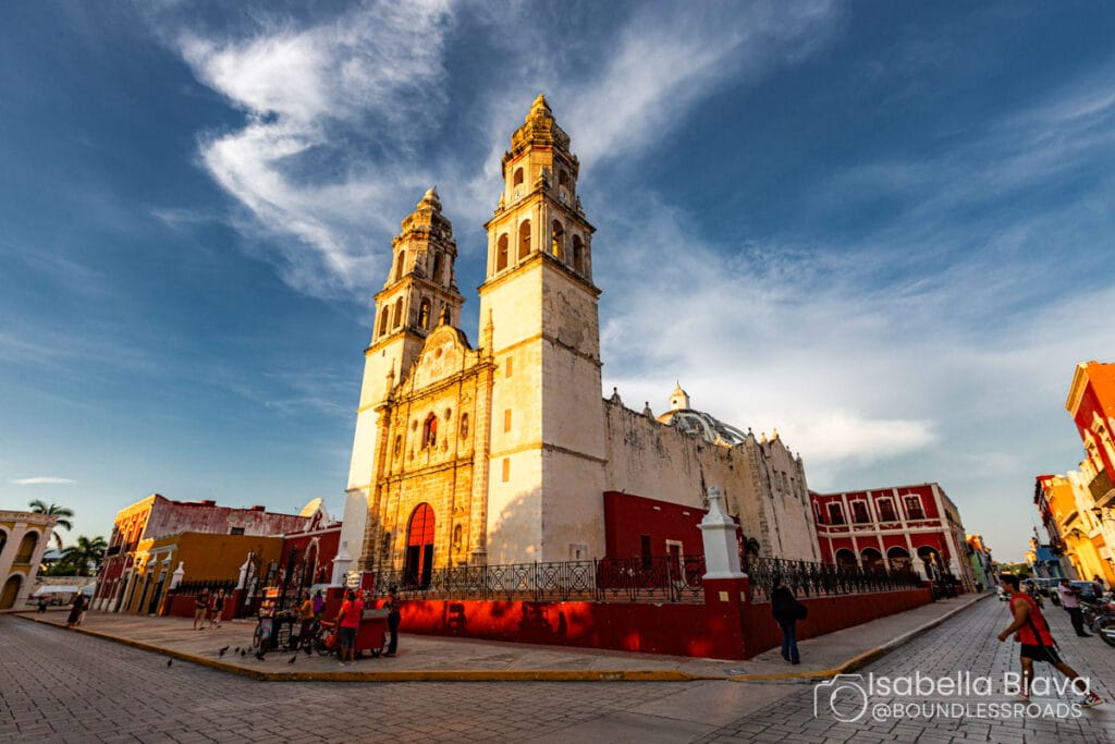 Historic cathedral in colorful city square, sunny day