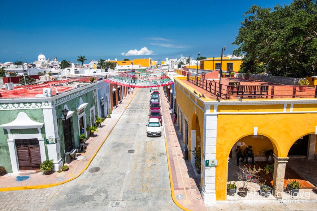 Colorful street with banners in colonial Mexican town.