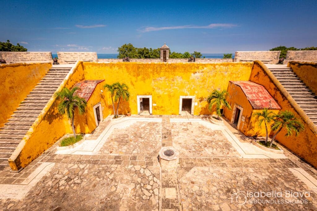 Yellow fort courtyard with stairs and trees