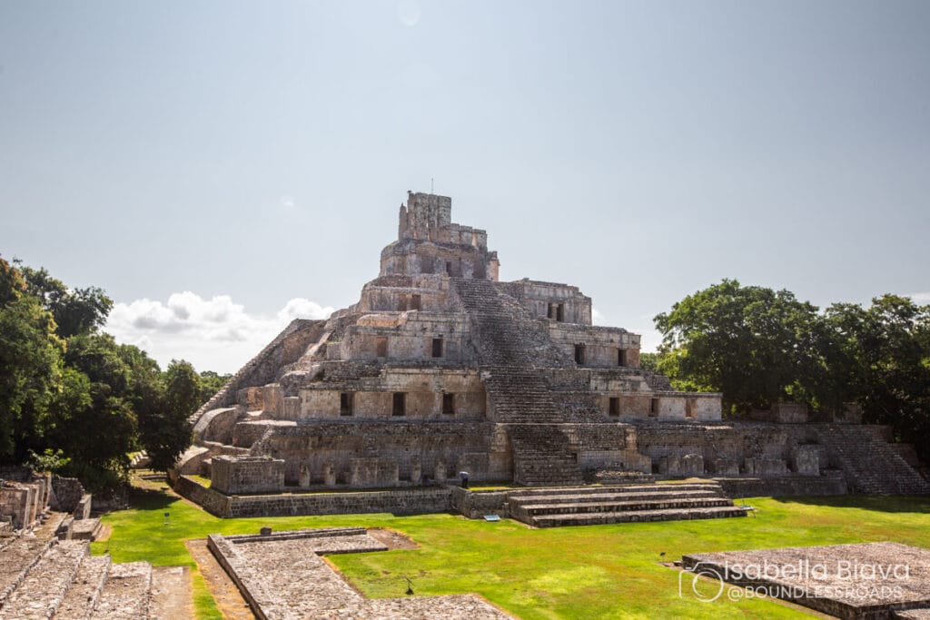 Ancient Mayan pyramid in lush landscape.