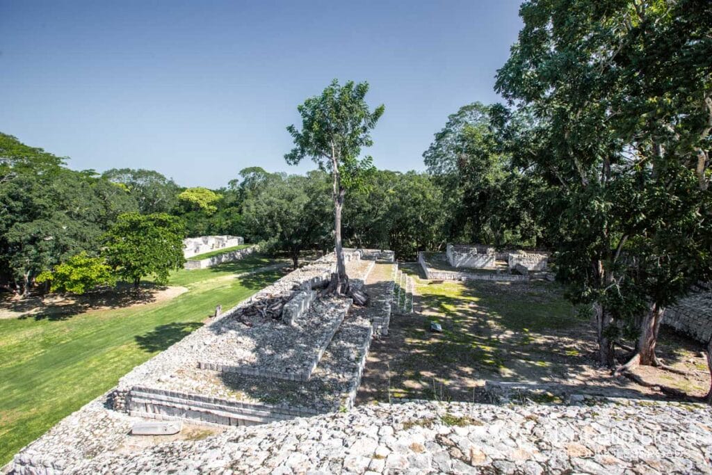 Ancient stone ruins with surrounding trees and grassland.