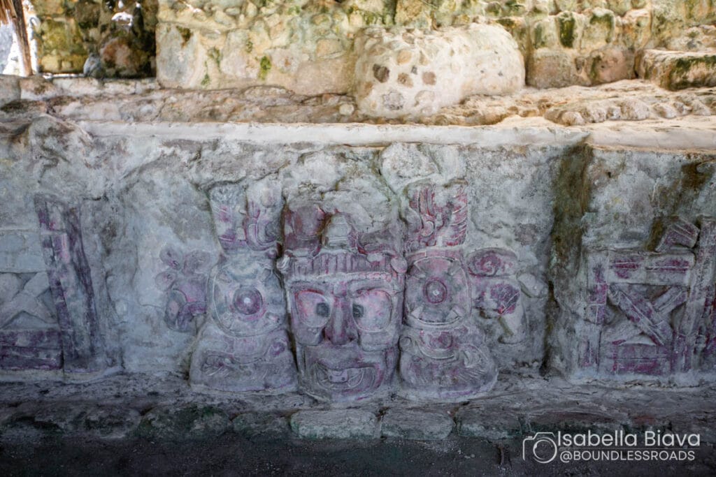 Ancient stone carvings with intricate patterns and faces.