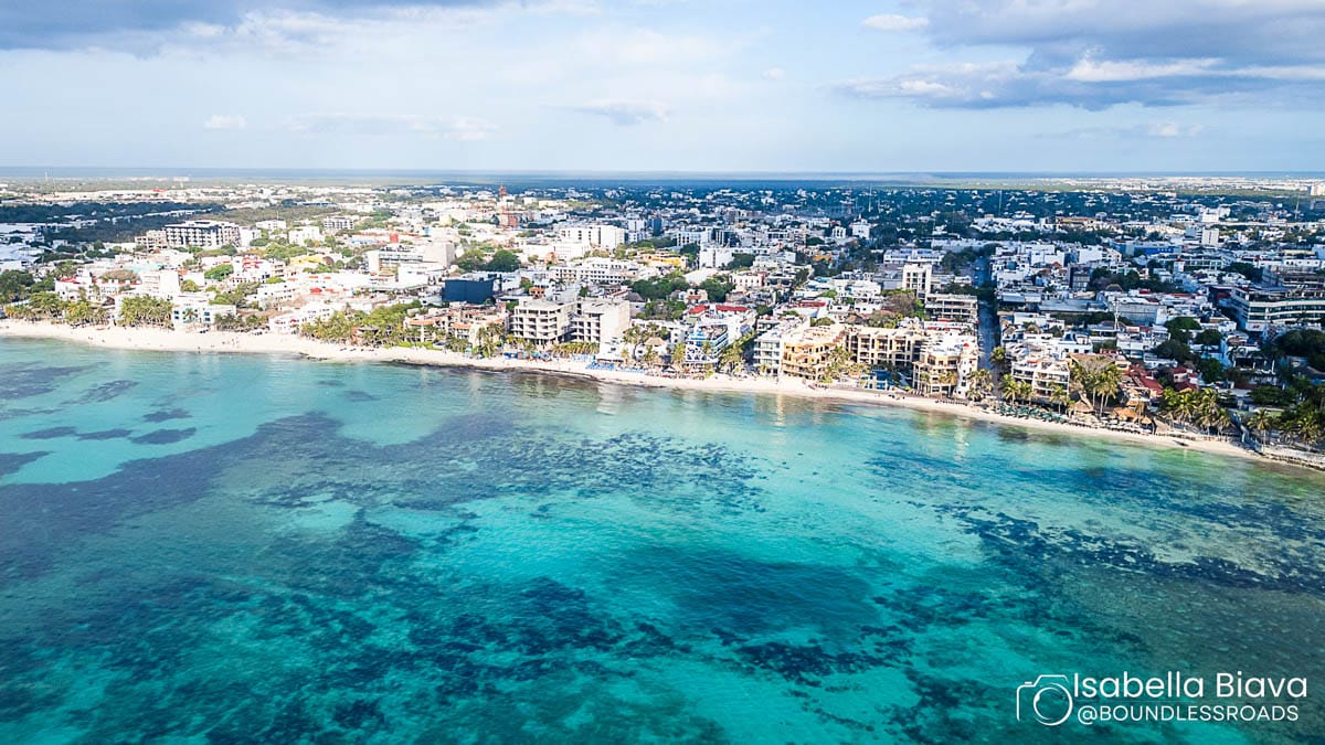 Aerial view of coastal city with beach and sea.